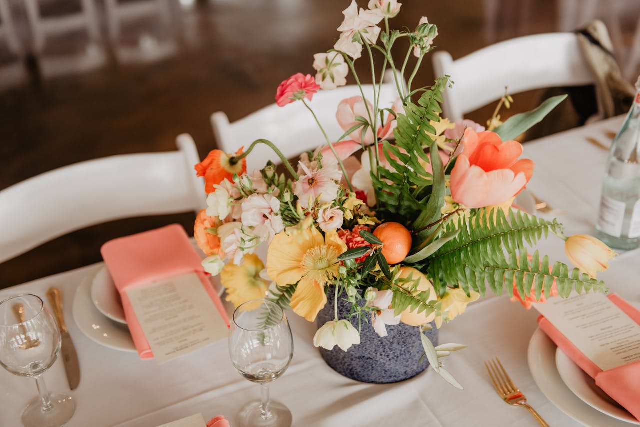 who-we-are A sophisticated table setting with a vibrant floral centerpiece perfect for weddings or events.